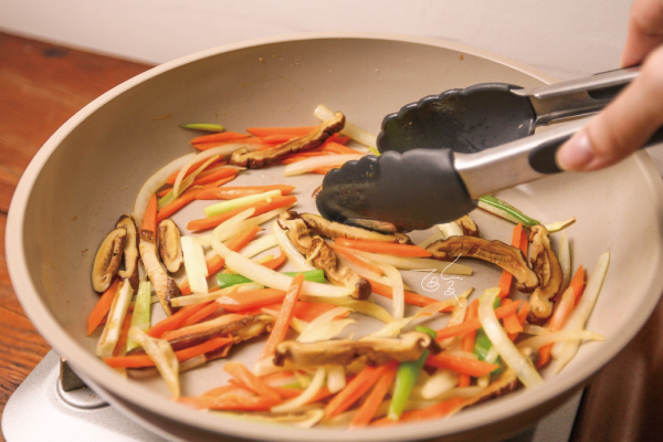 3.補一點油，加入蔥⽩、洋蔥、紅蘿蔔、乾香菇，炒⾄微焦。